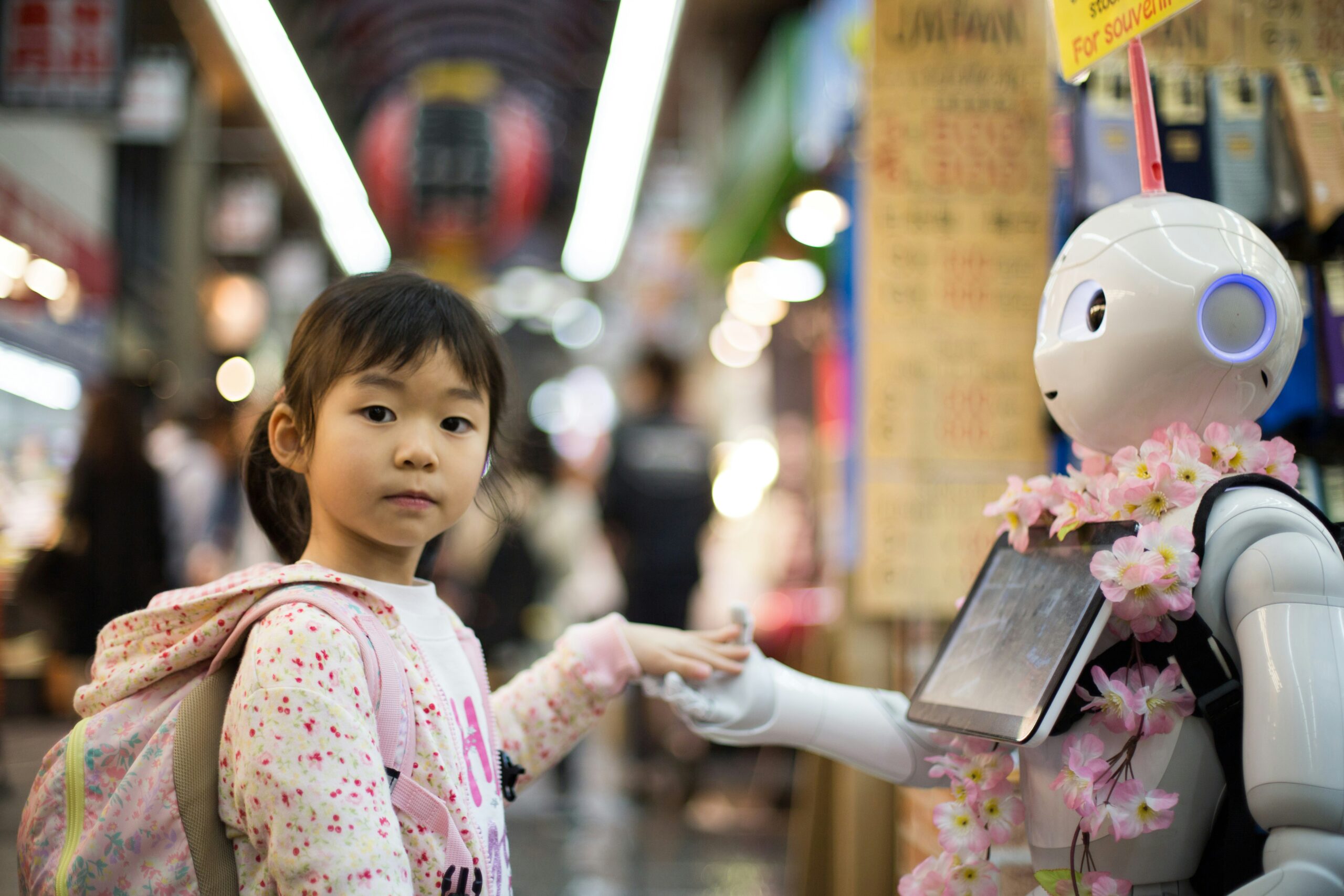 girl touching robot's hand